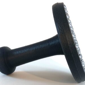 Tall handled black ball bearing baren lying on its side